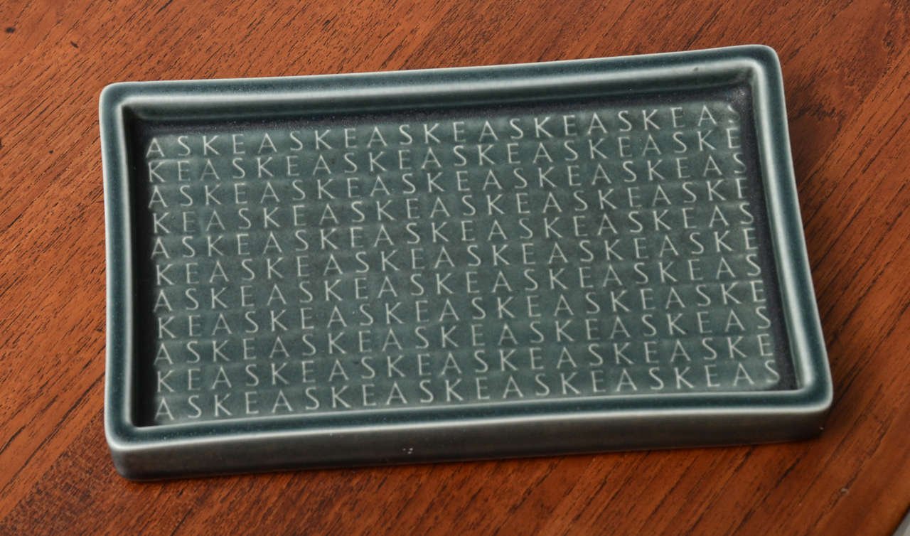 Ceramic tray with blue-grey matte glaze and raised pattern of letters (ash). Designed by Jens Quistgaard for Kroyn. Made in Denmark, circa 1950.