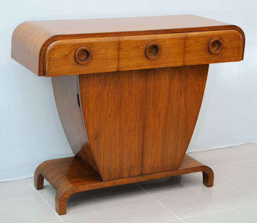 the 3 drawers over a pair of cabinet doors on a plinth, exhibited at Bloomingdales NYC in the 1950s in an exhibition of french art deco furniture