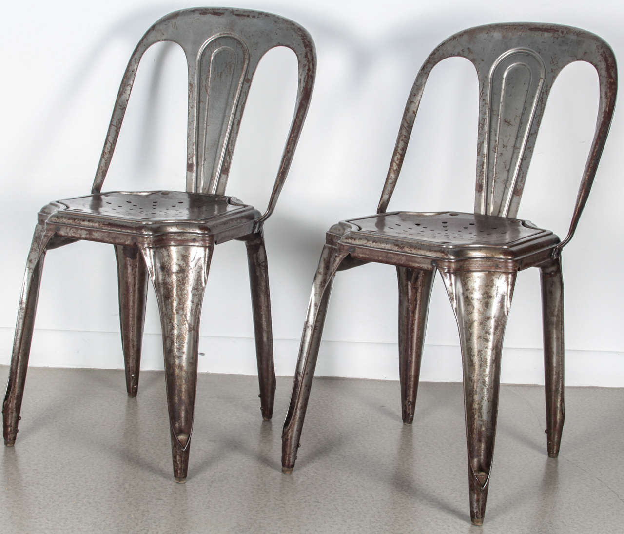 A set of four vintage 1940s metal Tolix chairs. These are NOT reproductions. These vintage metal Tolix chairs are the ultimate statement piece. They have been stripped and polished to reveal their natural beauty, making them perfect for any modern