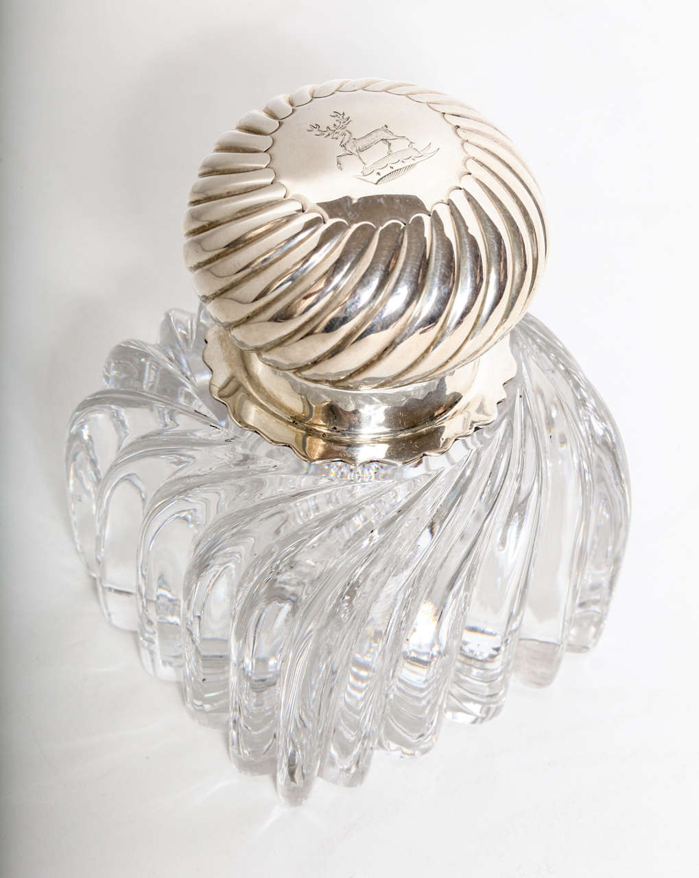 A beautiful late Victorian sterling silver and crystal body ink well.  The design runs through both materials as it appears to have been turned from the top through to the base.  The cartouche on the top of the lid has been beautifully hand engraved
