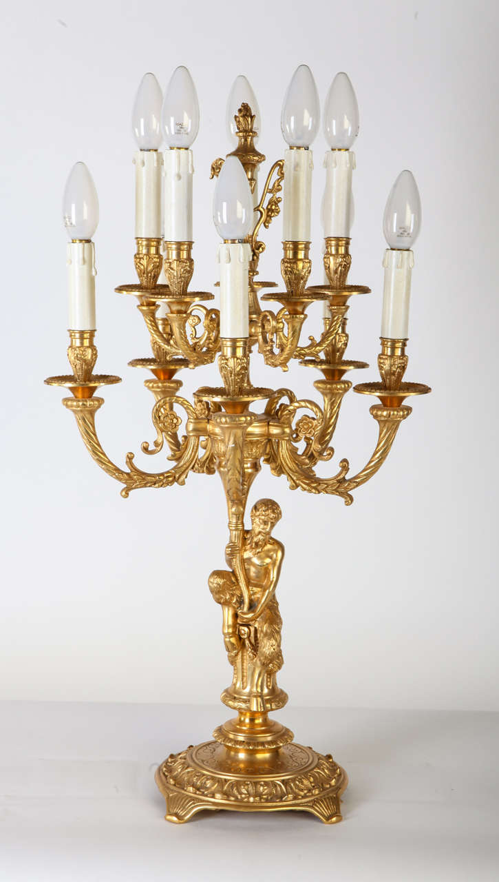 A fine pair of French gilt bronze candelabrum, each with in the form of classical pan figure supporting eight-scrolled candle arms.
Terminating with circular drip-pans and foliate candleholders.
circa 19th century.
Measures 66 cm.