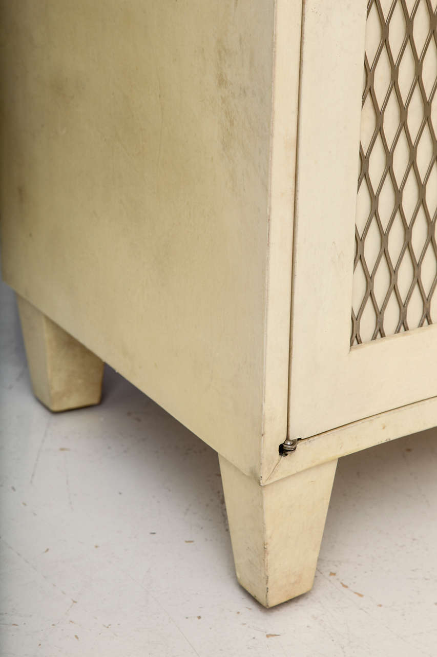 SAMUEL MARX (1885-1964)
Pair of parchment-clad two-door chests with concave fronts decorated with metal lattice decoration. 
Doors open to reveal 5 drawers.
American, c. 1940