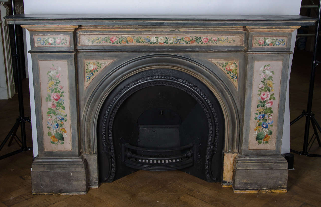 A truly magnificent fireplace surround with unique, hand-painted decoration. This impressive and precious chimney-piece has grand proportions with an elegant arched opening, wide moulded shelf and large jambs with substantial moulded footblocks.