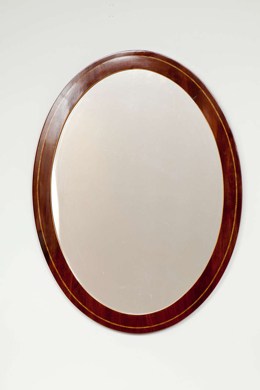 A Danish fruitwood inlaid mahogany oval mirror, Circa 1860s.