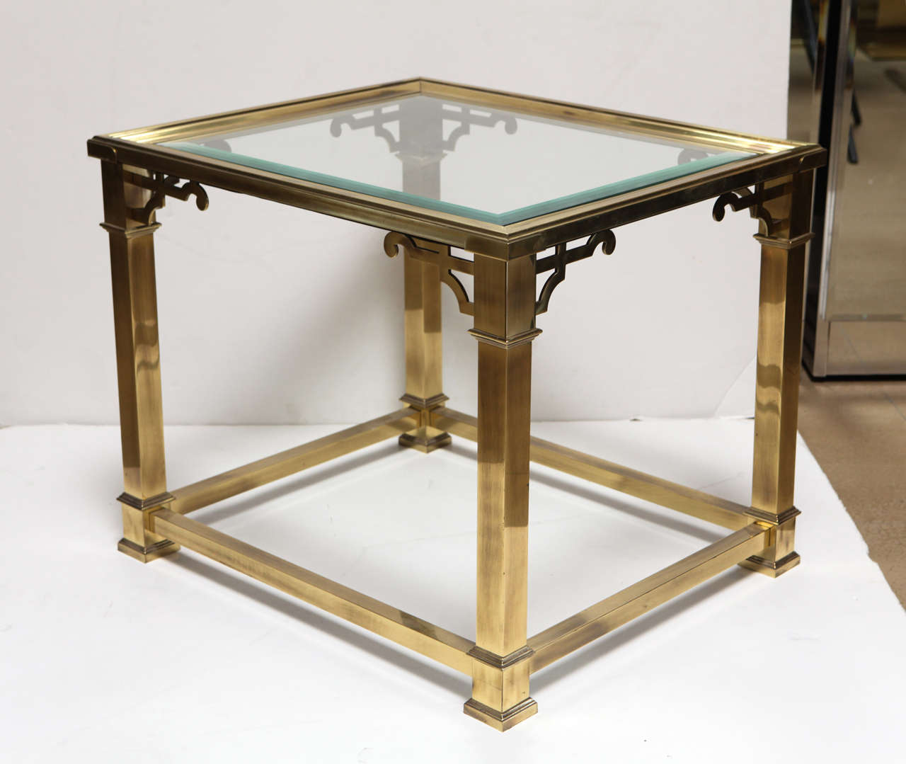 1960's Mastercraft side table in brass with inset glass top featuring Chinoiserie accents.