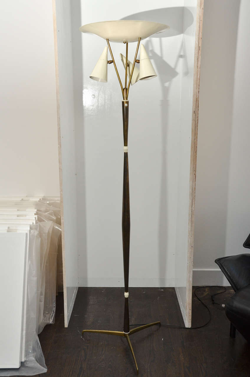 Italian brass floor lamp in the style of Arredoluce.
A round sauces shade and three adjustable cone-shaped shades connected to a brass stem ending with a tripod base.
Fully restored and newly rewired.