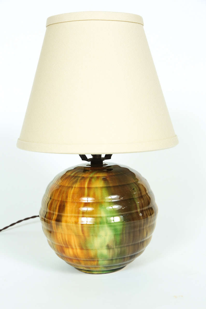 Small vintage pottery lamp with green and brown glaze newly rewired with a new linen shade