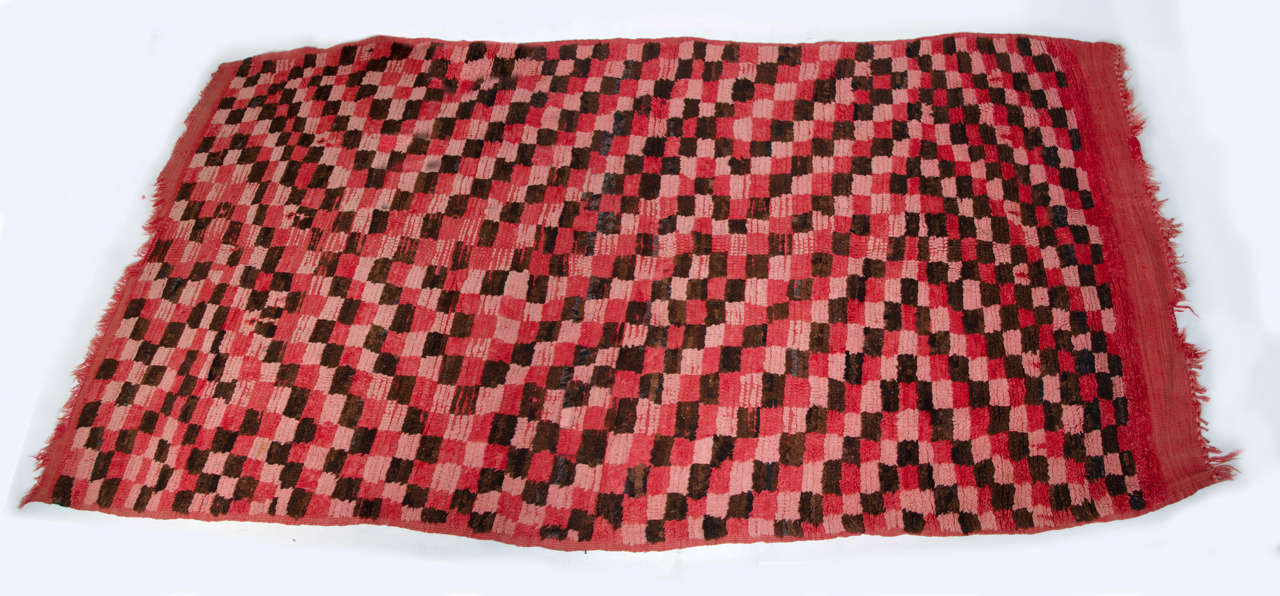 A 20th century Moroccan red and black rag rug.