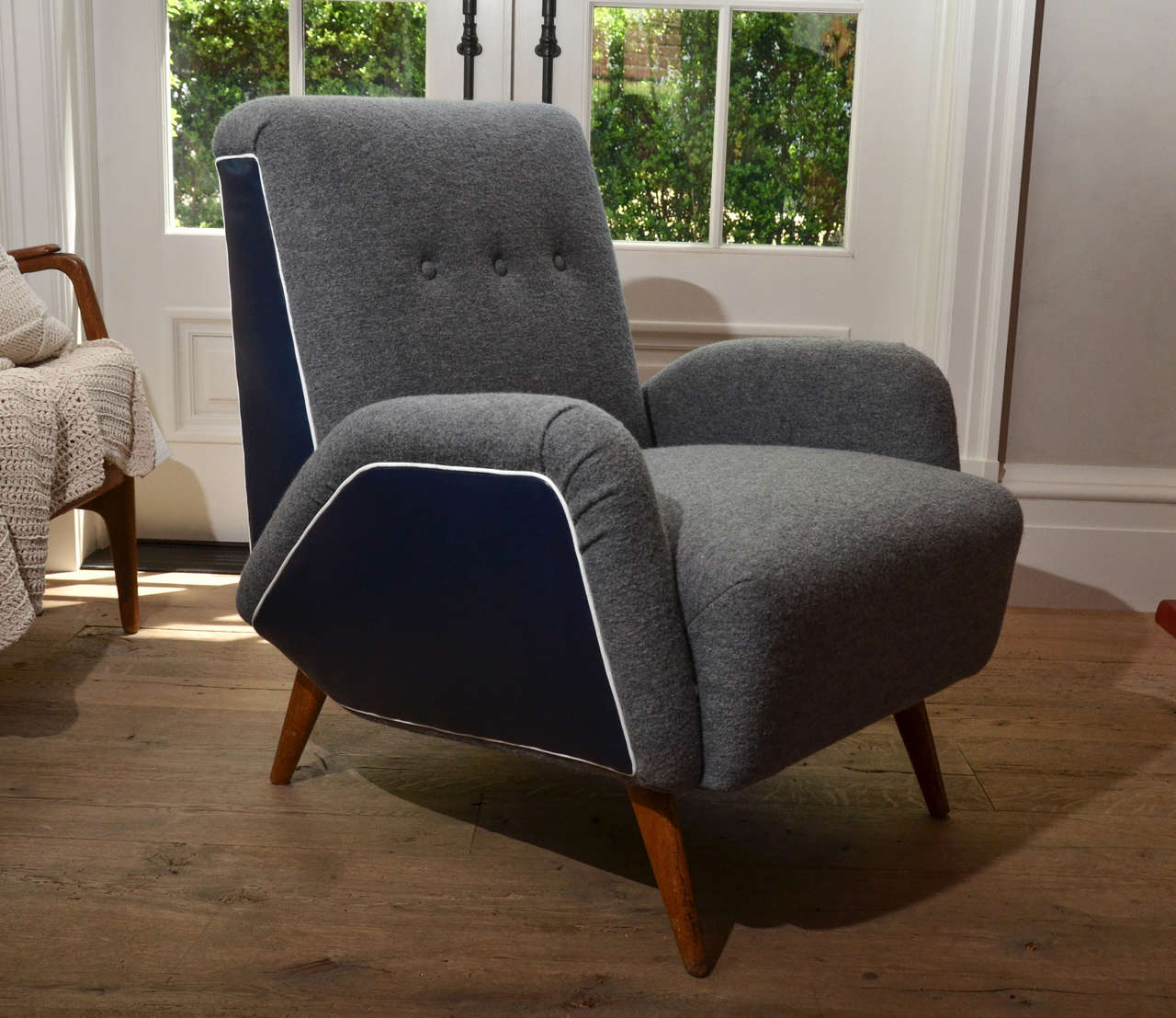 Stunning midcentury Italian armchairs newly re-upholstered in boiled wool with navy leather and white leather piping.
