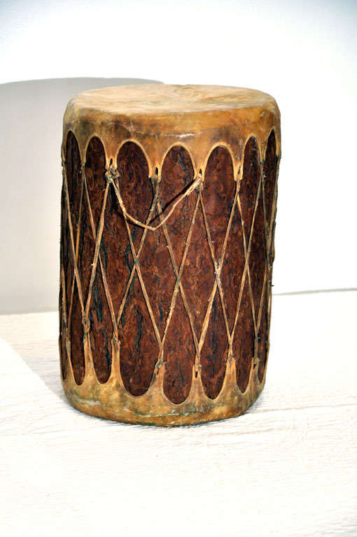 HAND MADE UNIQUE DRUM MADE FROM A HOLLOWED OUT LOG W/DEER SKIN STRETCHED OVER TOP AND BOTTOM.ALL HAND TIED W/LEATHER HANDLES.GREAT CONDITION