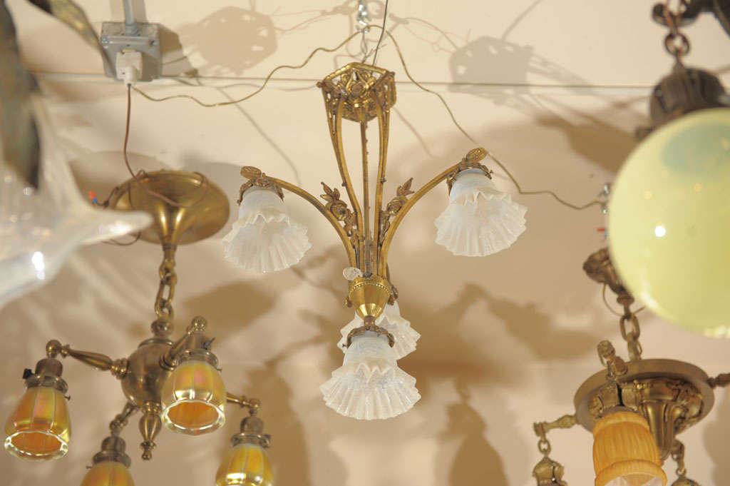 This lovely gilt bronze French chandelier has cast flowers and four original light blue deep-etched glass shades. Much more impressive in person. Perfect for a bedroom or smaller room.