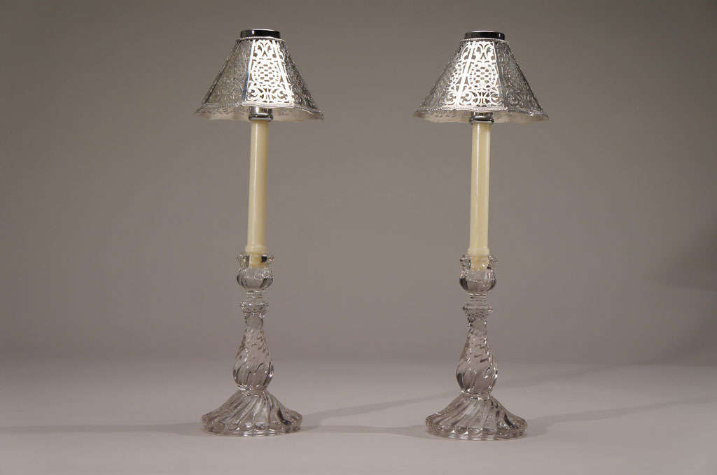 A lovely pair of unusual and heavy pierced candle shades made by Tiffany. These beauties are perfect sitting atop any pair of candles placed in your favorite candlesticks. A 