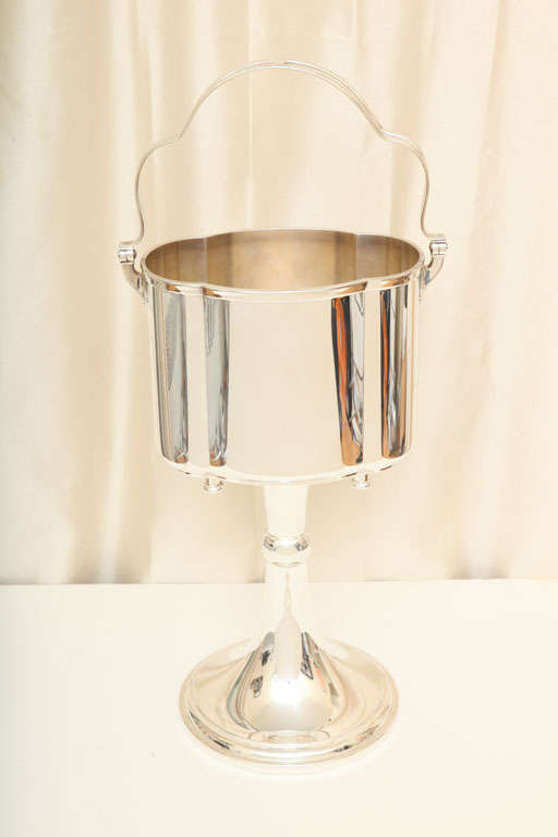 Large silver plated standing ice bucket by renowned silver firm WMF (Wurttembergische Metallwarenfabrik). Clean design with stylized moveable handle. Marked 