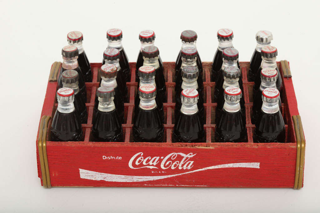 This is an original and very rare complete box of  Coca-Cola bottle advertising cigarette lighters produced in the 1950's by the Kem Company. This was a very popular promotional giveaway which Kem produced for beverage companies at the time. The two