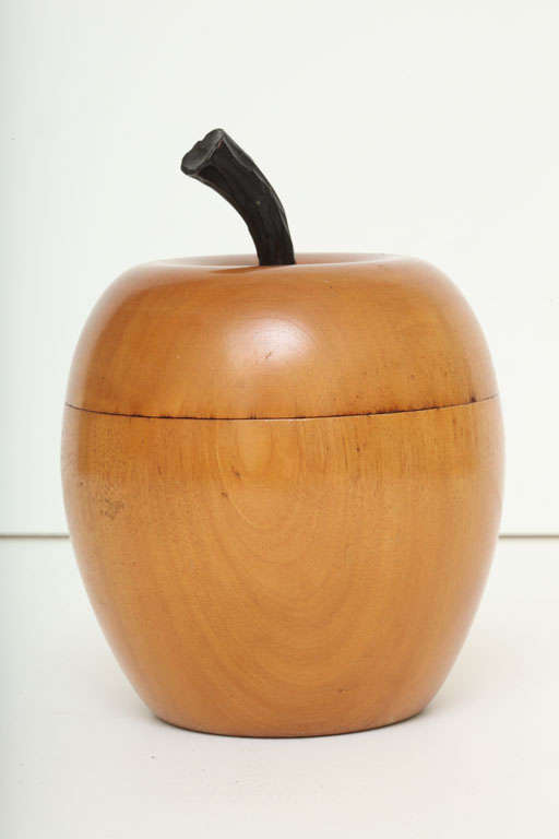 A beautifully hand carved and clean looking one piece carving of an apple that can be used for loose tea leaves, or purely decorative.  It has a wonderful patina to the wood.  The piece is finely carved, cut and then hollowed out from one piece of