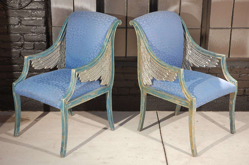 French Empire style armchair featuring a scroll back and carved wing motif finished in blue, gold, and gilt