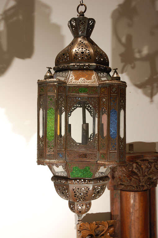 Very nice handcrafted Moroccan glass pendant.
This multi-color glass Moorish style lantern is rewired for electricity with a cluster of three lights.
Comes with chains and ceiling canopy, chains could be adjusted to your needs.
Handmade by skilled