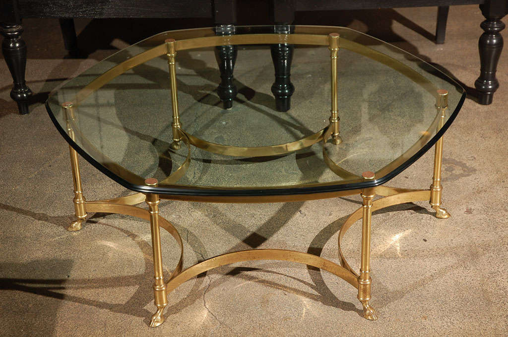 Sculptural beveled 3/4 thick beveled glass table on high quality polished gilt brass stand with six brass legs terminate in a Ram's hoof.
OctagonalGlass and gold polished brass metal coffee table From Maison La Barge.
Made in Italy