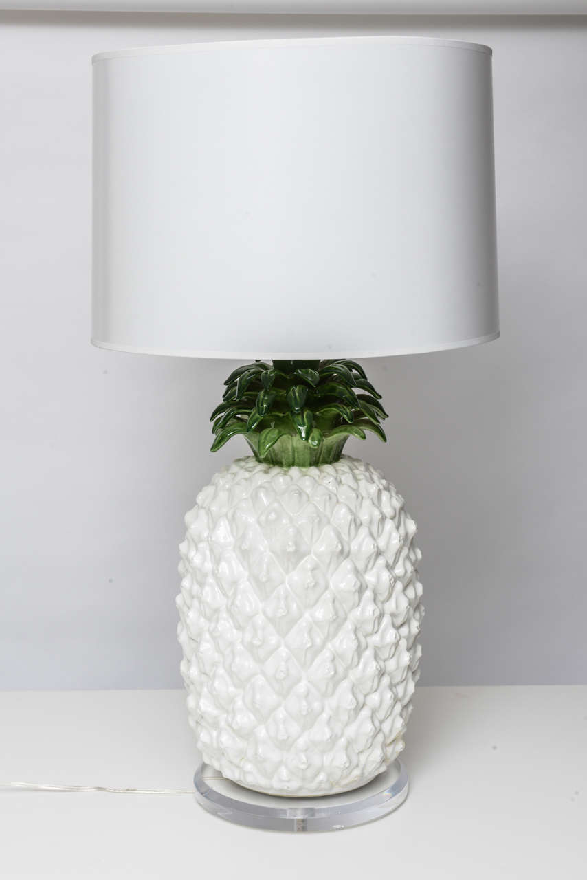 Very Palm Beach chic glazed terra cotta pineapple lamp on Lucite base. Completely rewired with new drum shade.