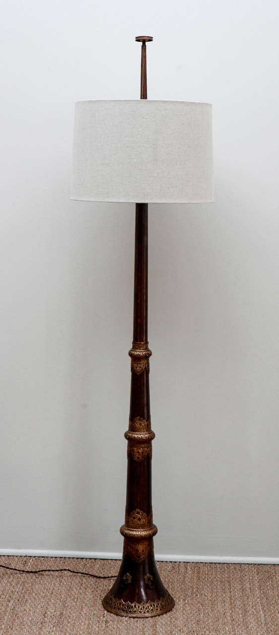 Floor lamp made from a Vintage Tibetan Monk's Trumpet with embossed brass and inset glass beads. 8 inch finial made from trumpet mouthpiece. Custom Linen lampshades with difussers; newly wired. 

74