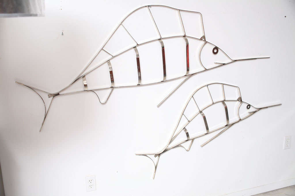 TWO METAL FISH SCULPTURES PLATED IN A SHINY NICKEL FINISH , THEY ARE DIFFERENT SIZES . THEY HAVE BEEN TOTALLY REFURBISHED AND RE-PLATED.THEY ARE PRICED FOR THE PAIR