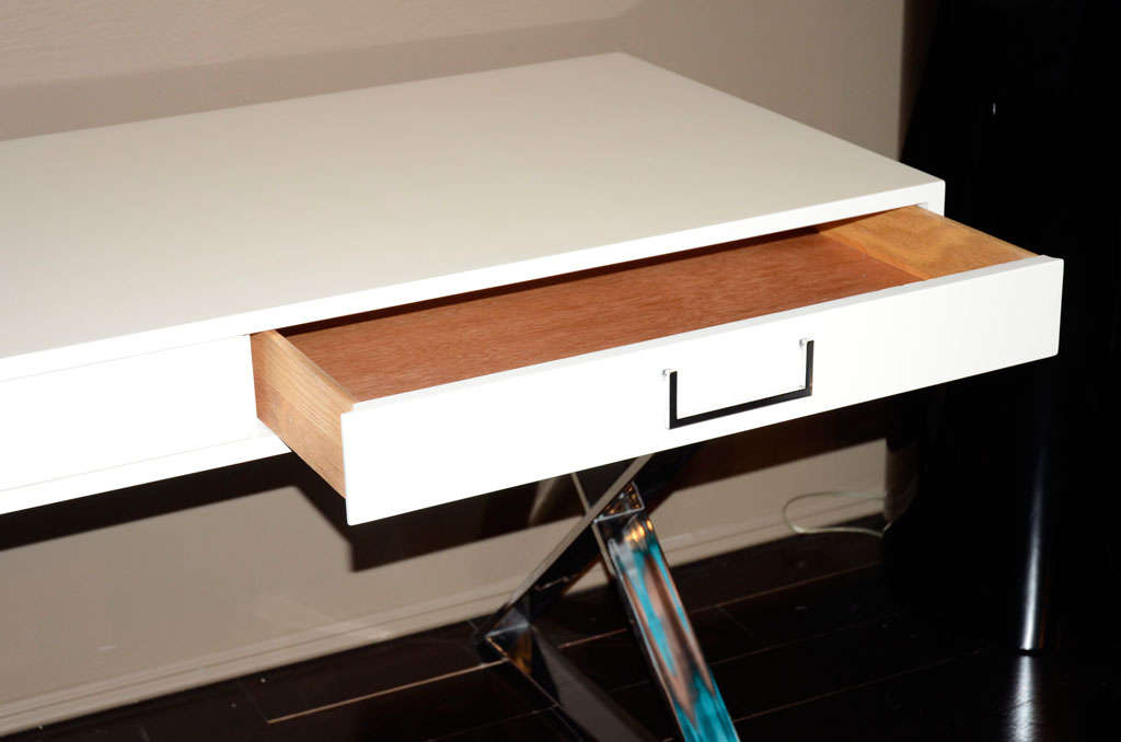 Milo Baughman 1970's white lacquer campaign desk with chromed steel x frame base.Two drawers with metal handles.