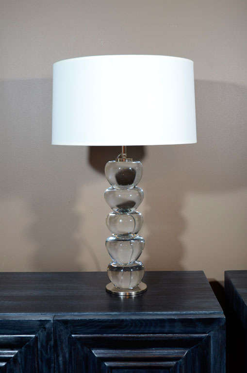 Stacked amorphic clear solid glass sculpture lamps on satin nickel-plated brass circular bases. They are double socketed, with nickeled brass hardware. These are custom-made and can be ordered in multiples.