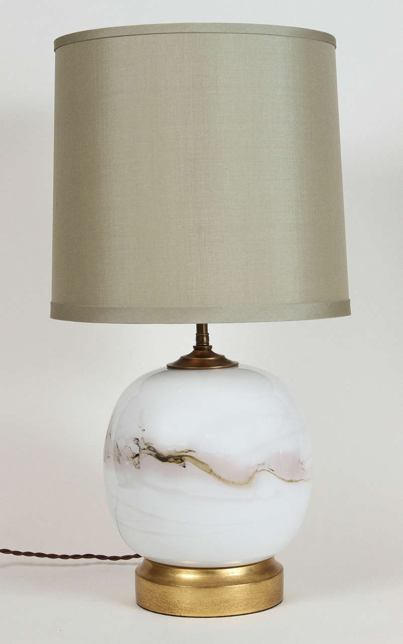 Pair of vintage round Holmegaard handblown opaque white glass table lamps with light mauve/pink marbled detailing. Designed by Michael Bang for Danish glass manufacturer Holmegaard. Bang has worked for Holmegaard since 1968. Features a 22k gold gilt