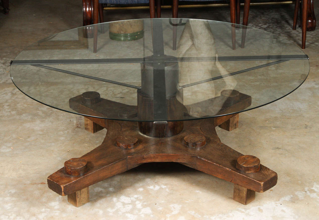 Round glass top coffee table made from English ship port part with metal base. 