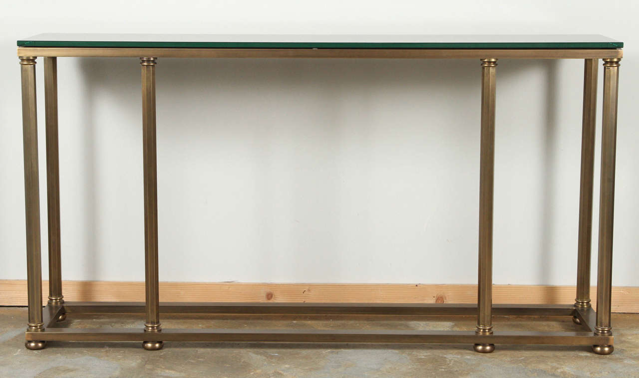 Mid-Century brass Italian console with new antique brass finish and reverse-painted glass. Console can be turned either way as preferred, refer to all photos.