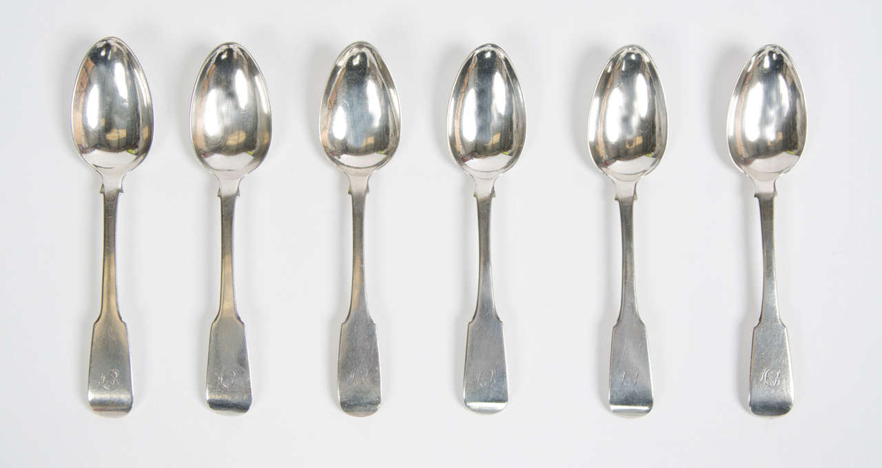 A set of six fiddle pattern Elgin hallmarked silver tea spoons made by William Ferguson circa 1820 - 1830. Length of spoons 14cm widest point of the bowl 3cm. Initials EF in scroll form engraved to the top of the fiddle handles.