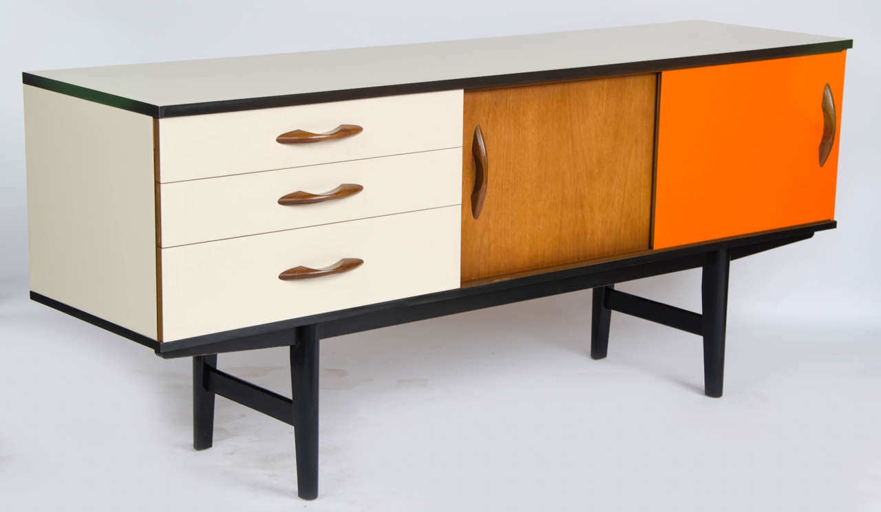 A nice example of an early 70's British Avalon Sideboard. Reload have completely refurbished the cabinet, adding colour laminates in cream and orange and black ebonising the leg frame and edgings.