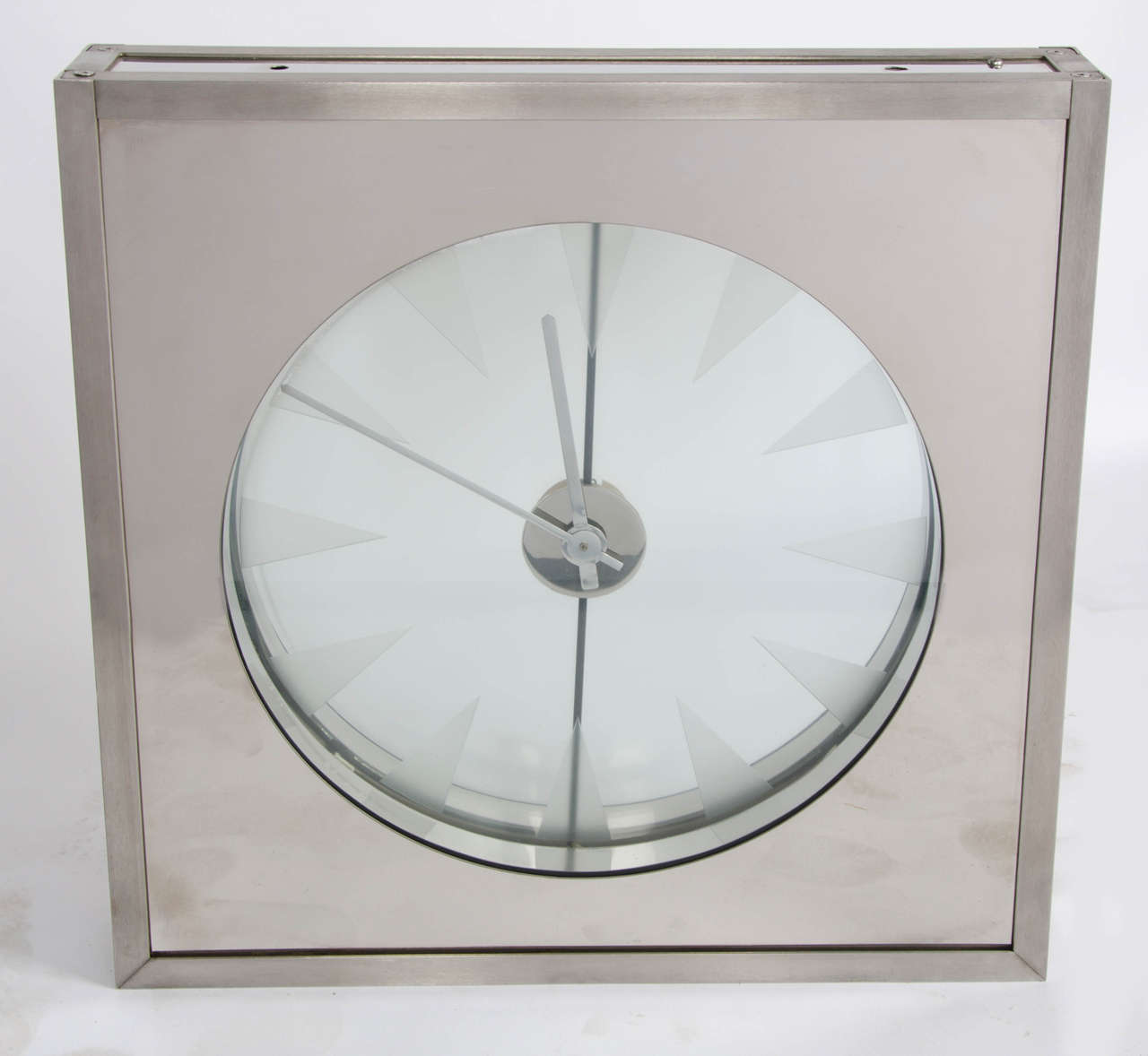 Aunique  hanging clock commissioned for the Royal Bank of Ireland in the 1960's. The clock is contained in a polished aluminium and stainless steel frame. The face features acid etched sections surrounded by white neon illumination. Hanging fittings