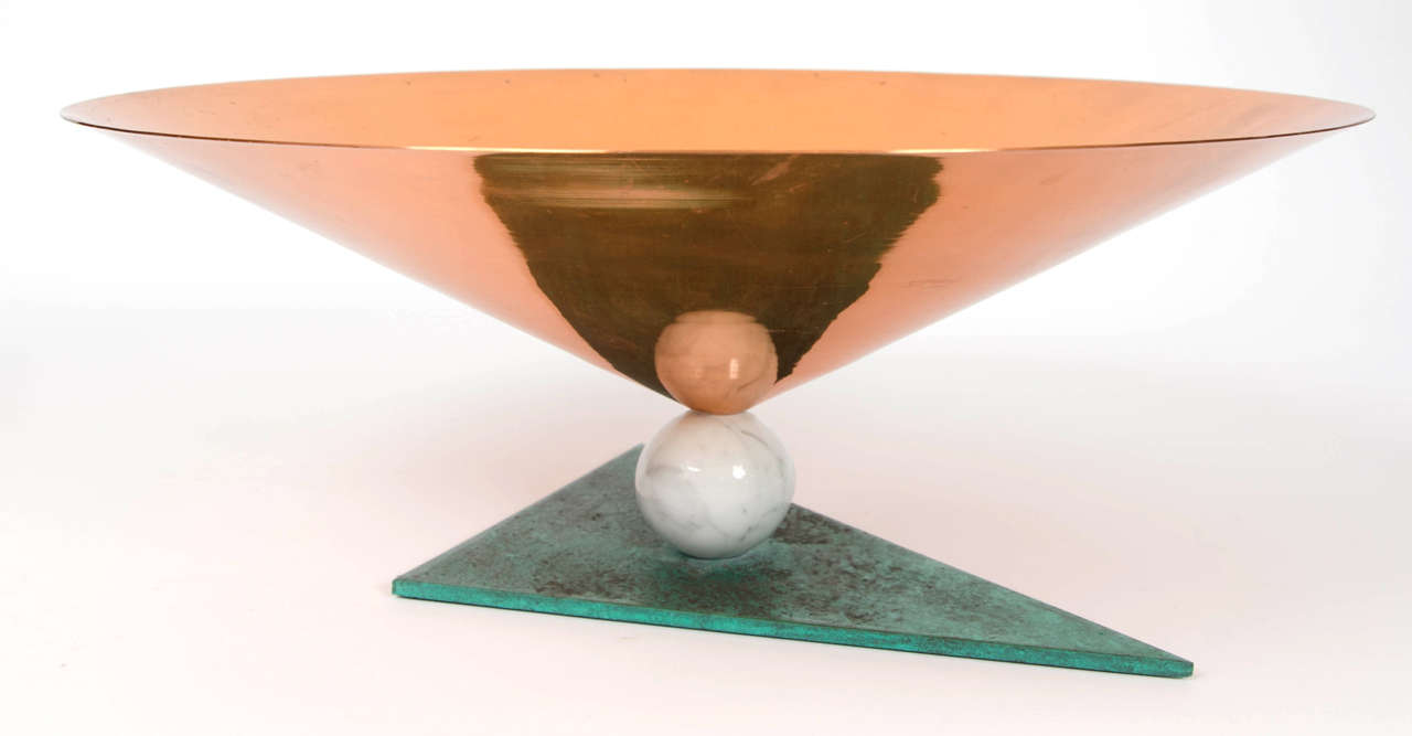 Center piece in tree materials, copper cone shape bowl, marble ball shape foot and a triangular patinated metal base.
By Match Thiene, Italy.
Dubbed  the 'New International Style'. Memphis was a reaction against the slick, black humorless design