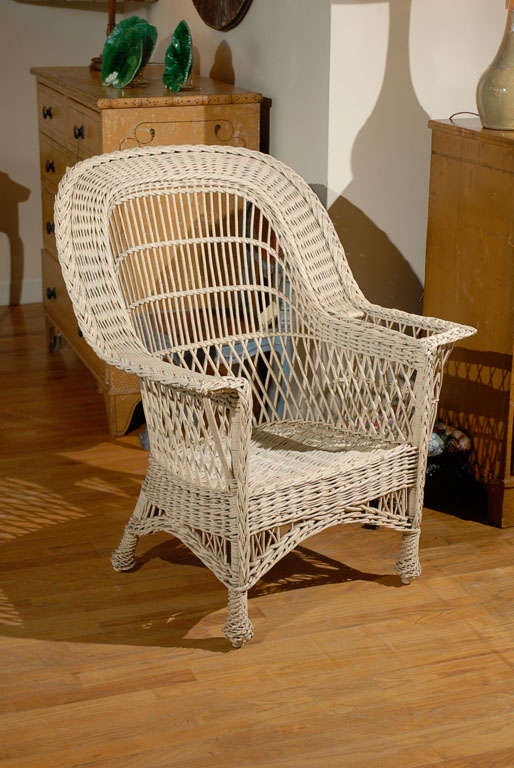 Bar Harbor wicker was produced from about 1910-1920s.  It is a wonderful stream line appeal that can be found in modern settings or cottage settings.  This chair has four pineapple feet and a magazine pocket.  It is a beautiful piece of