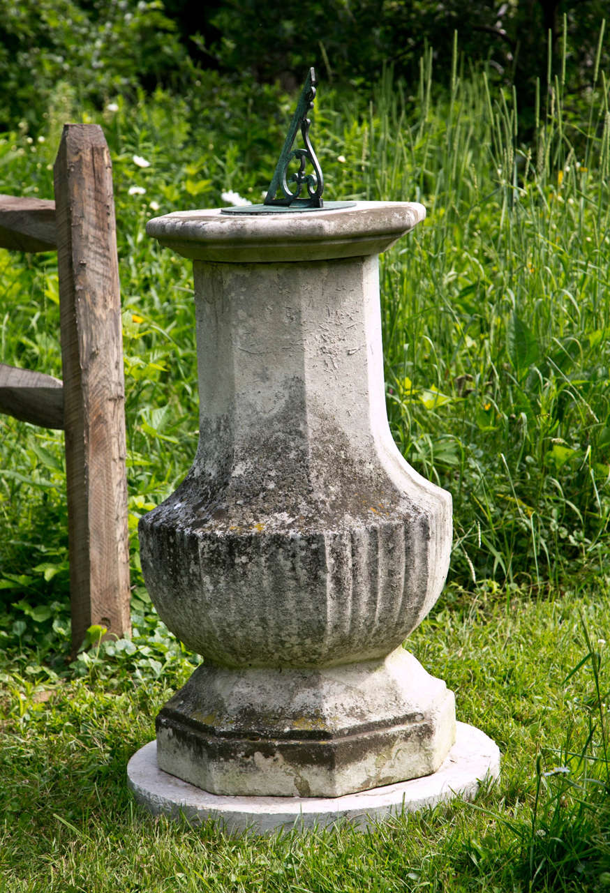 A carved Portland stone sundial with associated bronze dial plate stamped Armstrong of Manchester, English, the pedestal ca. 1860, the dial ca. 1900.  48 ins. high overall, pedestal 39 ins. high, gnomon 9 ins. high, 22 ins. overall diameter.  The