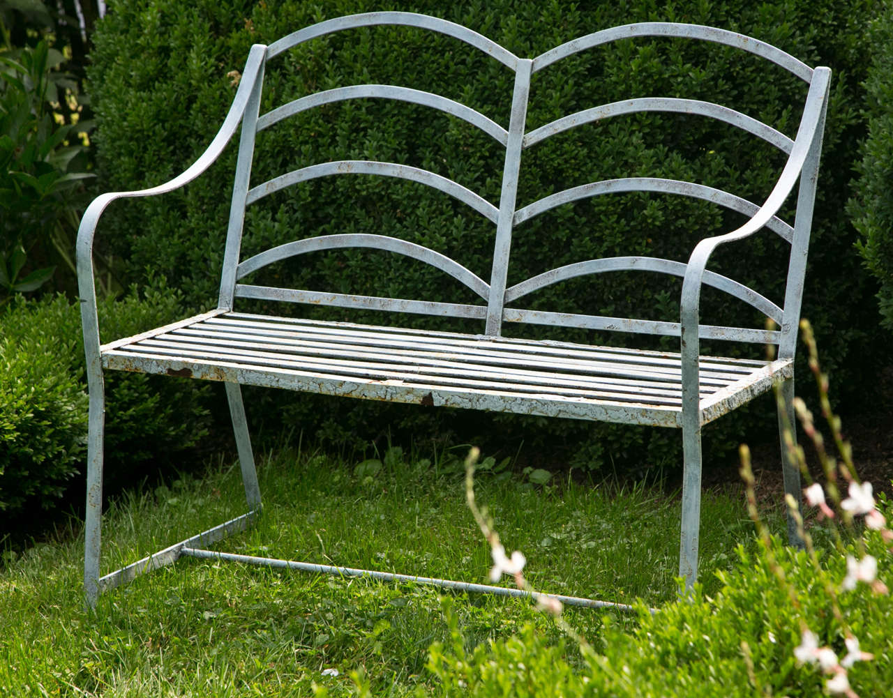 A small wrought-iron Regency-style seat.