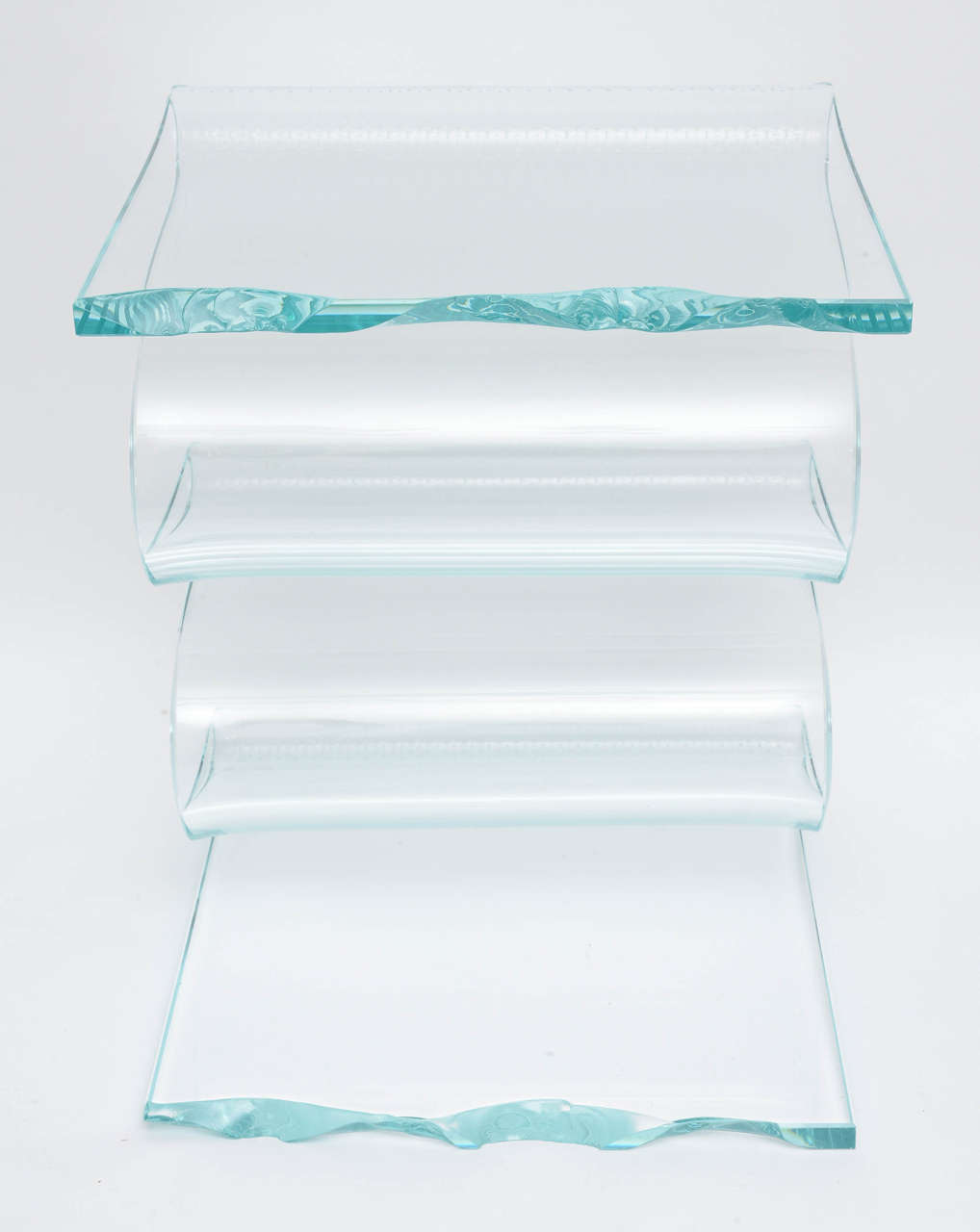 Striking curved and flowing solid glass side table.