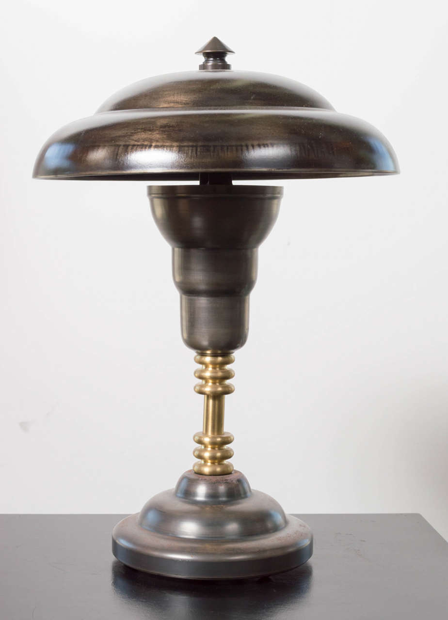 This handsome table lamp is made of steel and brass. In excellent condition and has been fully rewired with a top of the line cloth cord.