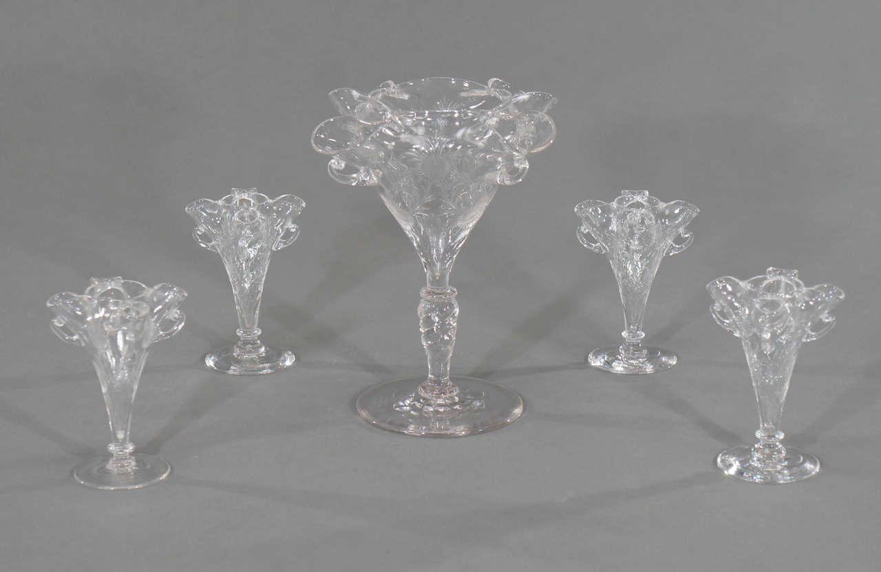 A rare and amazing signed Stevens and Williams hand blown centerpiece set, all matching, all in excellent condition. Each vase has all-over copper wheel engraved decoration, twist stem and applied handles. The five pieces could be connected with