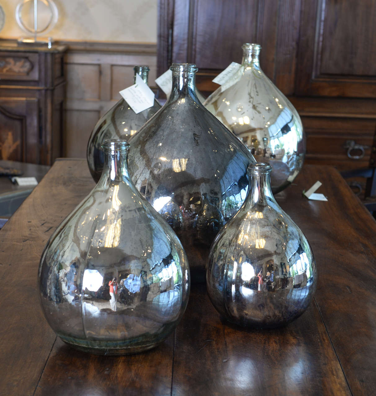 There are seven of these 19th century calvados bottles which have recently been coated with mercury.  They are specked and shaded giving them the wonderful look of very old mercury glass.  The smallest one is 12