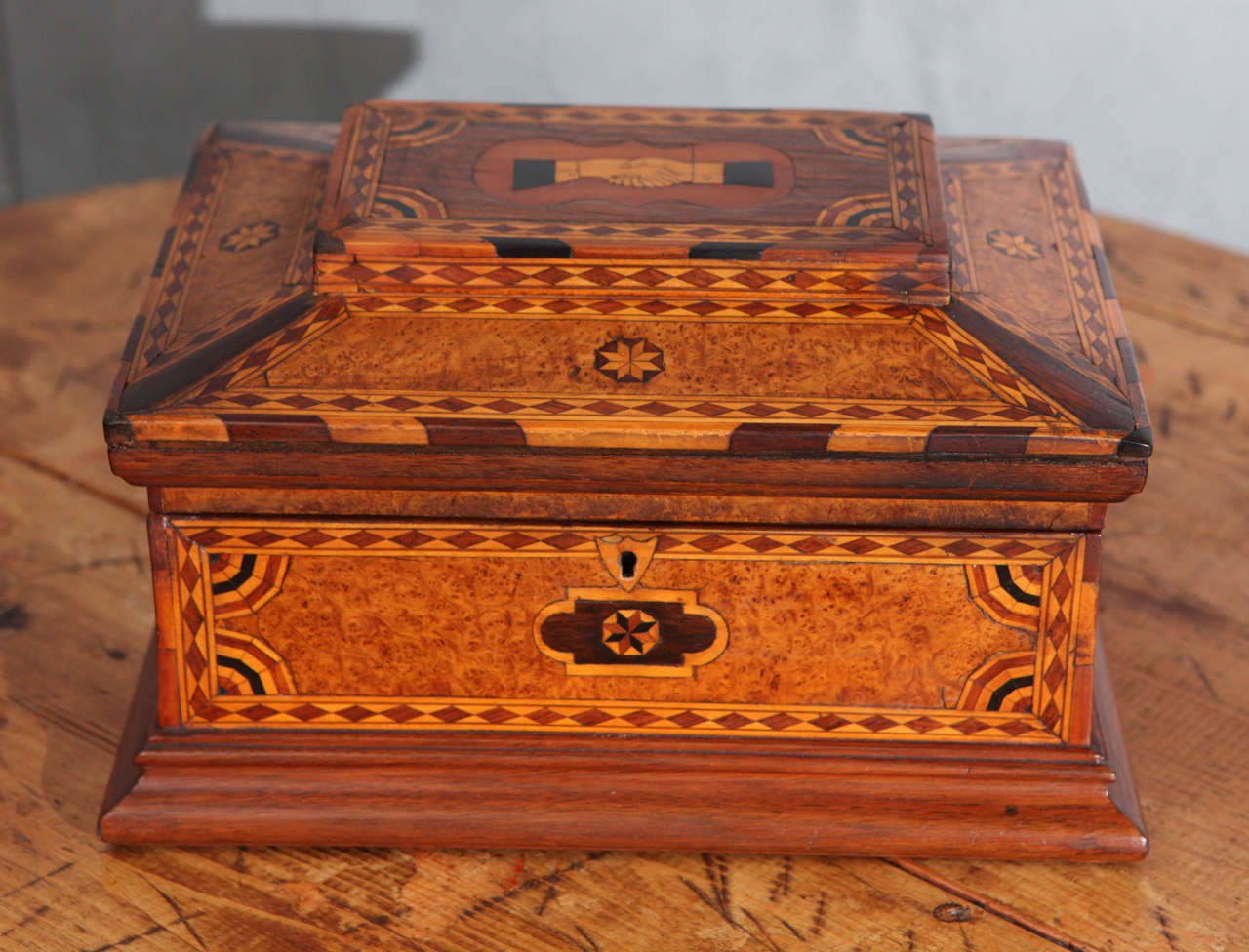 This beautiful box has the Odd Fellow symbol of the hands of friendship inlaid in marquetry and wonderful parquetry geometric patterned designs on all sides of this unique piece of history. Note how the nice contrasts of the various woods used