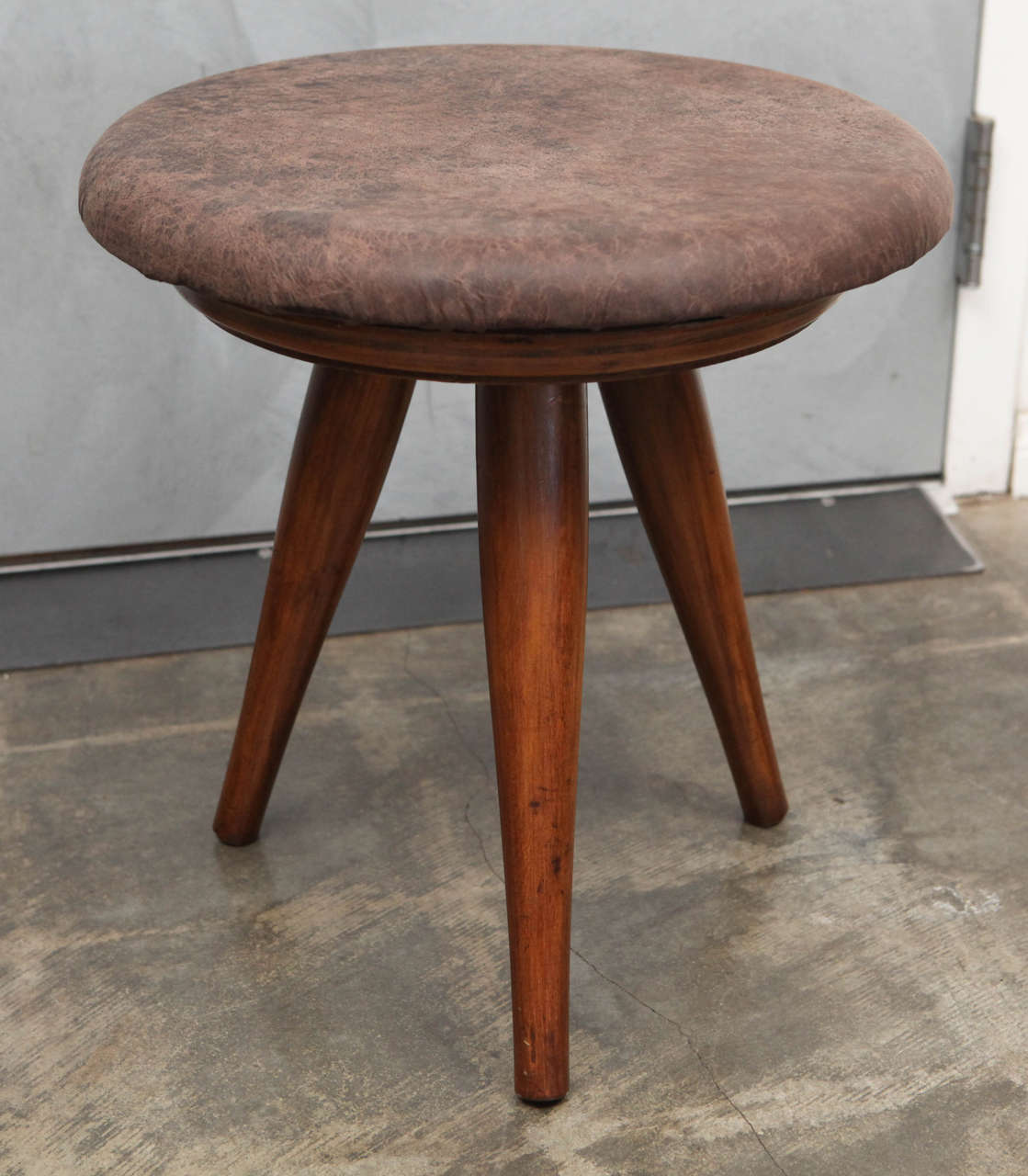 This great little stool is a great example of 1960's design with the Tapered Tripod legs, nice simple design lines. We have used a great soft, distressed brown leather to upholster the swiveling seat to make it a unique piece for a variety of themes