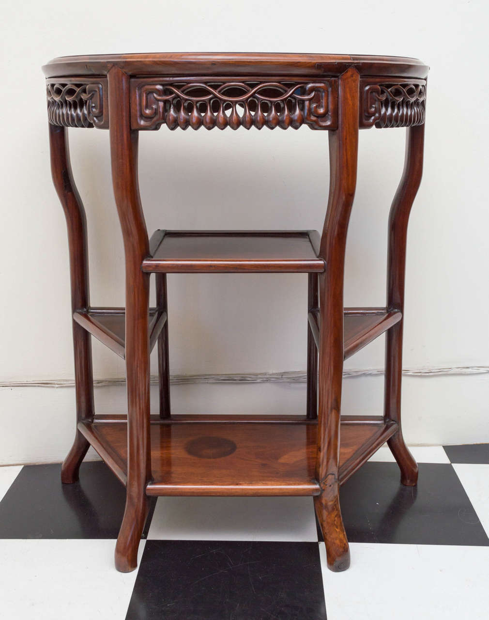 Late 19th century Chinese Hong Mu Hardwood demilune form table. Shaped legs, fitted shelves and interesting carved apron design.