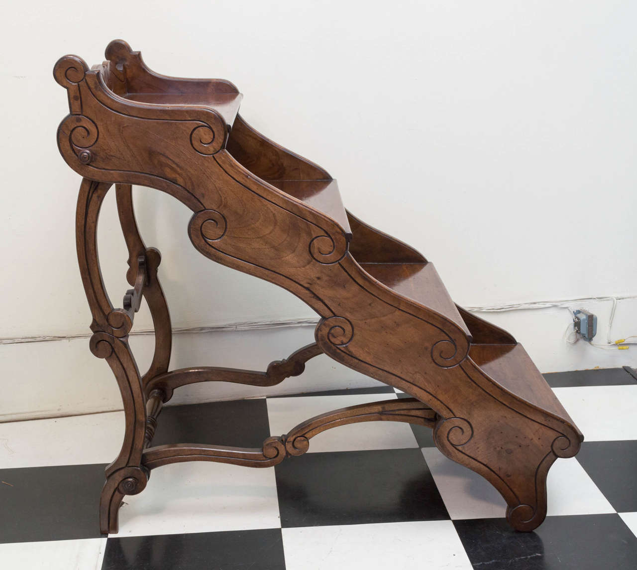 Late 19th c. English library stairs of walnut wood. Shaped frame with 4 steps carved and inscized decorative details. Paste wax finish. Good deep steps. Victorian.