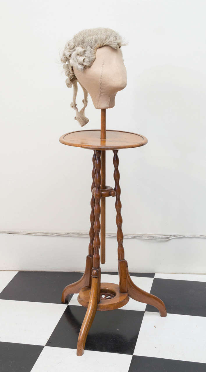 19th c. English William IV Wig  Stand With Wig. Faded warm rosewood wig stand with an early horsehair wig (1790 - 1810) on a linen  canvas head form. The height of the wig adjusts with a turn screw set below the top of the table surface.