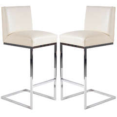 pair of bar stools in leather polished stainless steel by Brueton