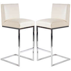 pair of bar stools in leather polished stainless steel by Brueton