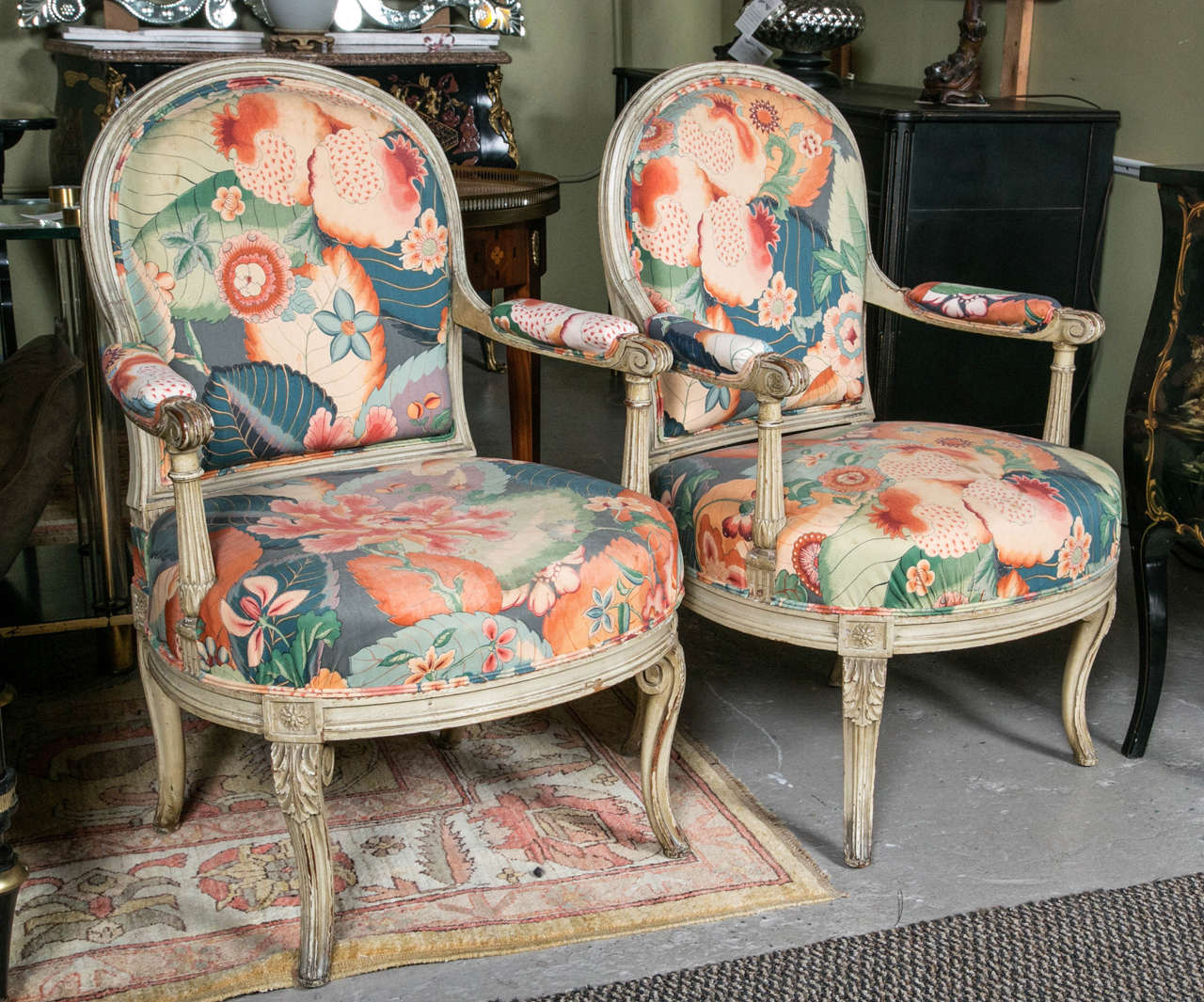 Set of Four  carved and paint decorated fauteuils by Maison Jansen.  The turned carved legs supporting a circular apron with a fine hi stuffed cushion set leading to column form arms with upholstered armrests. The backs with matching wood frames by