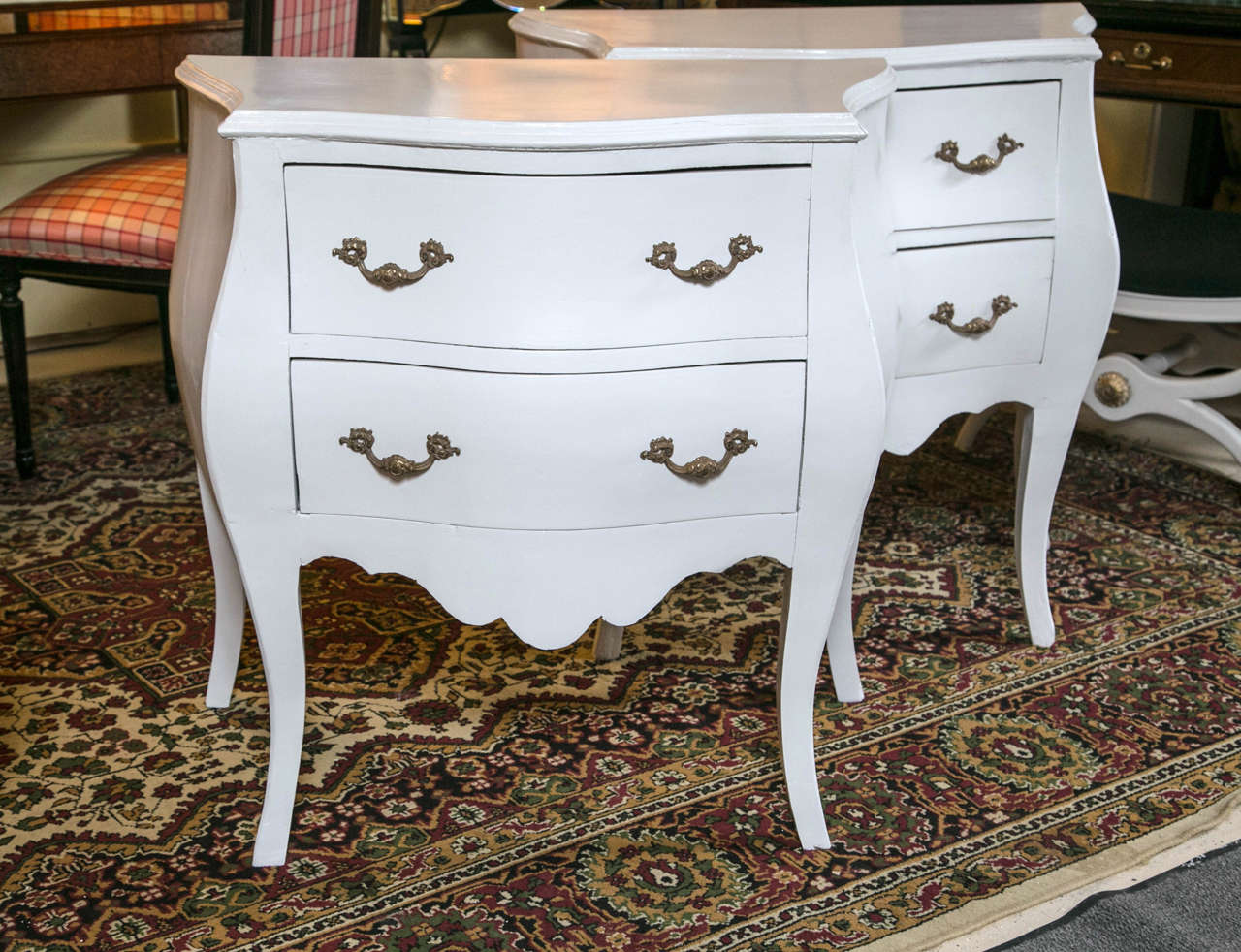 A pair of white bombay chests or nightstands with brass hardware. Sensational color, size and style. Wonderfully made for any room would work gloriously as side/end tables/nightstands! White is in the color of summer. The Fine feminine curved apron